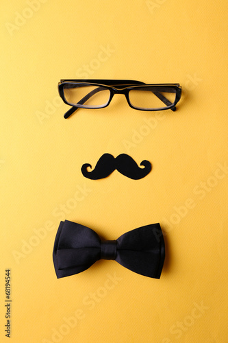 Glasses, mustache and bow tie forming man face