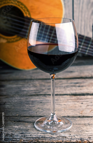 guitar and Wine on a wooden table