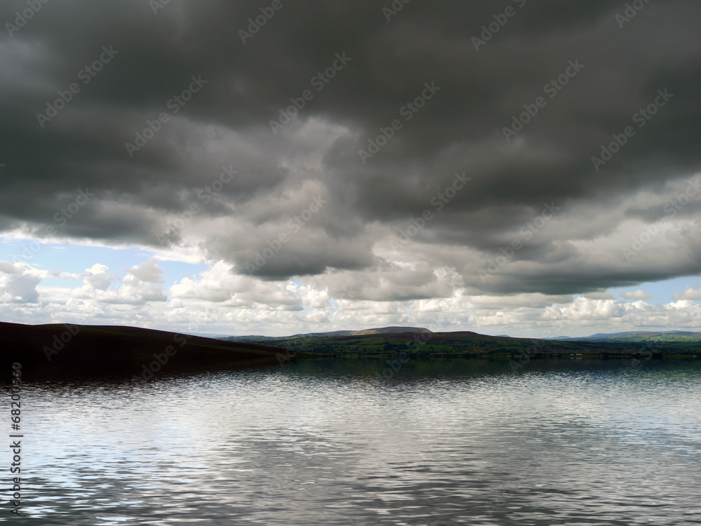 Moody clouds over water