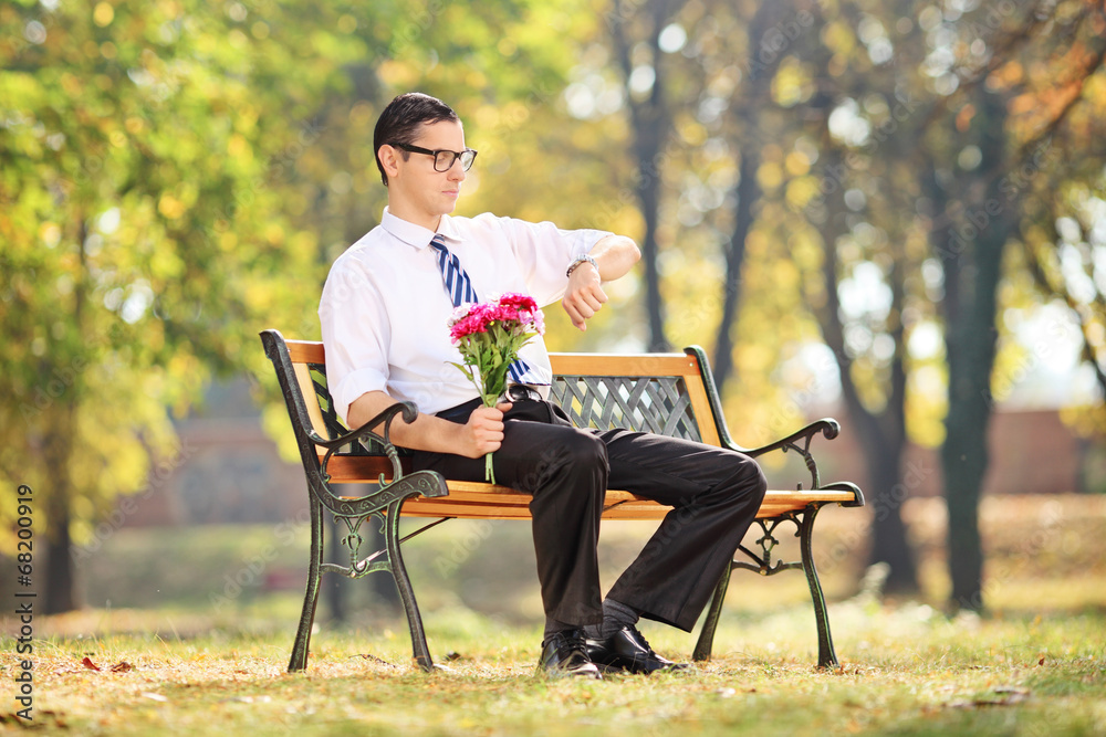 Young guy waiting for his date in park Young guy waiting for his date in park