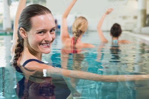 Female fitness class doing aqua aerobics photo