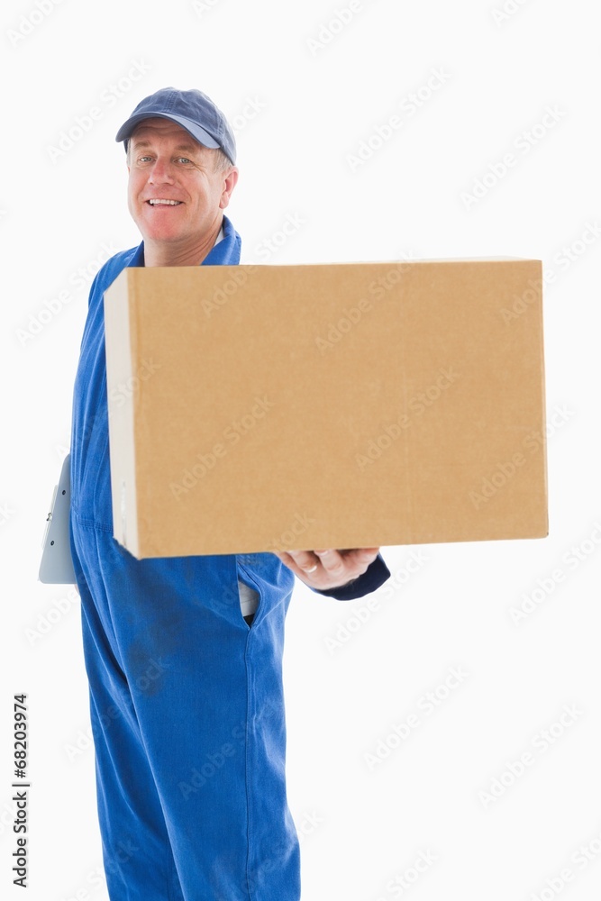 Happy delivery man showing cardboard box Happy delivery man showing cardboard box