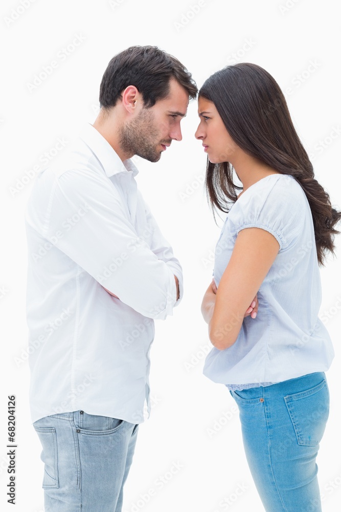 Angry couple facing off after argument Angry couple facing off after argument