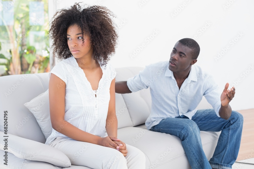 Attractive couple having an argument on couch Attractive couple having an argument on couch