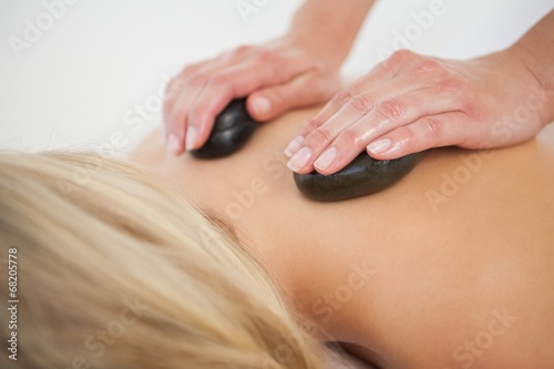 Beautiful blonde enjoying a hot stone massage