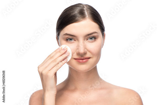 Beautiful woman removing facial make-up