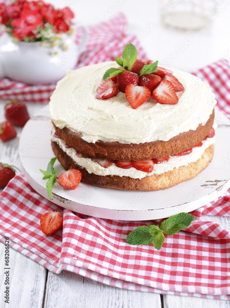 Delicious biscuit cake with strawberries on table close-up Delicious biscuit cake with strawberries on table close-up