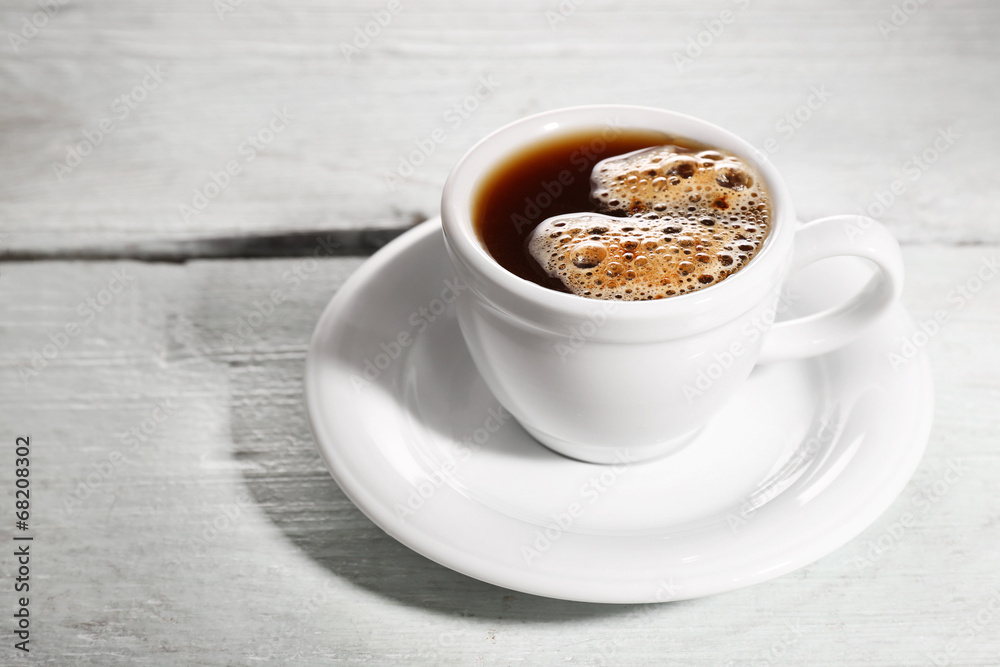 Cup of coffee on color wooden background Cup of coffee on color wooden background