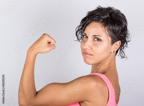 Funny Young Woman Showing Muscles