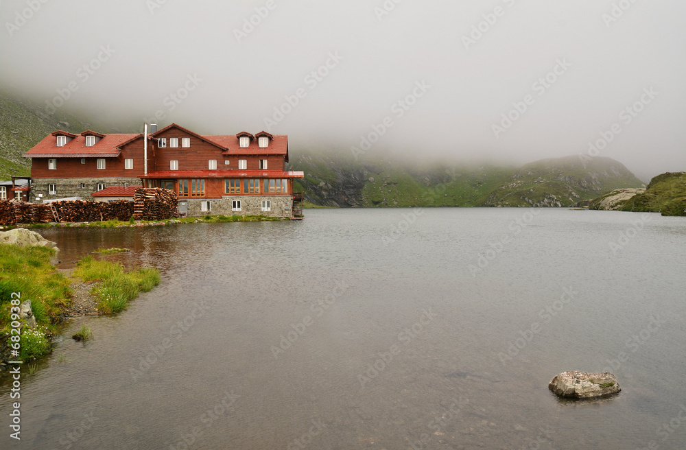Fototapeta premium mountain hut and lake