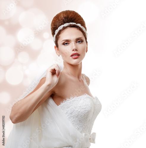 Beautiful bride in white wedding dress with hairstyle and makeup