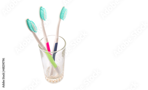 Tooth brush in a glass over white background 