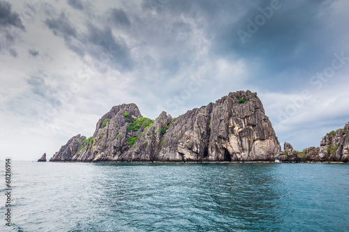 Tropical rock island against blue sky and  sea