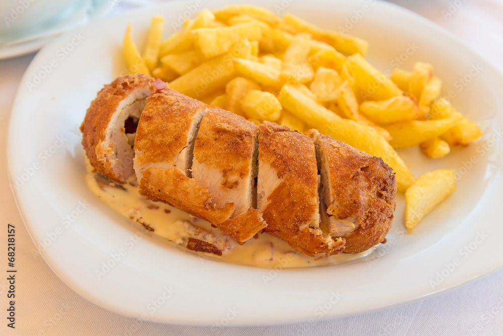 Chicken roll stuffed with vegetables with white sauce and frenc Chicken roll stuffed with vegetables with white sauce and frenc
