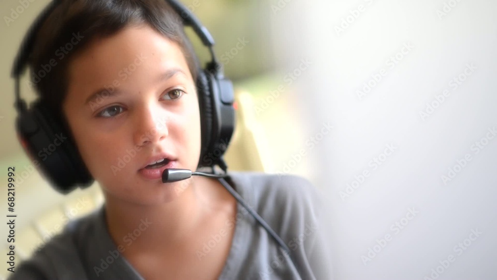 Child playing on the computer with headphones Child playing on the computer with headphones