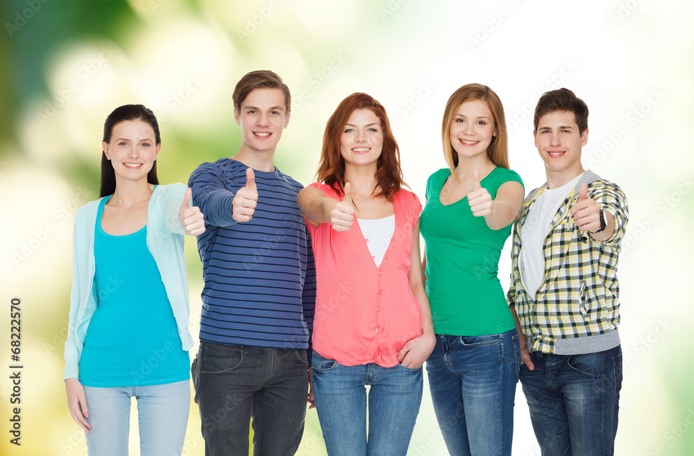 group of smiling students showing thumbs up group of smiling students showing thumbs up