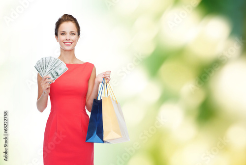 smiling elegant woman in dress with shopping bags