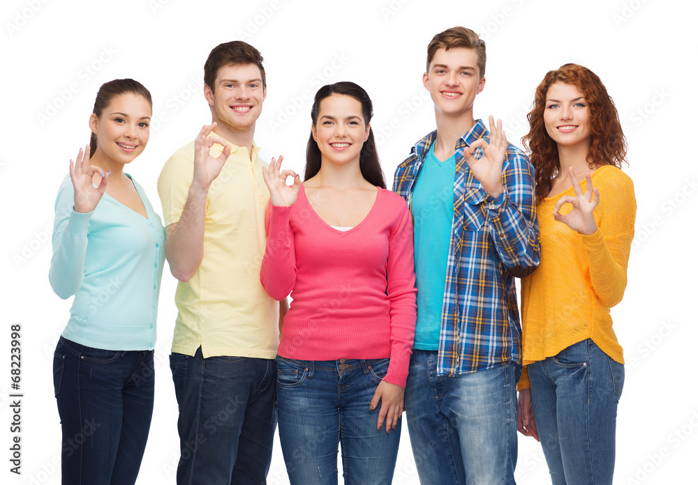group of smiling teenagers showing ok sign group of smiling teenagers showing ok sign