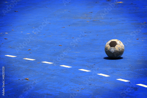 Old ball in a blue cement field