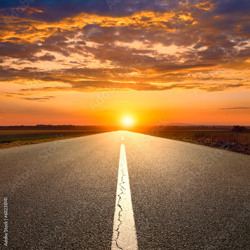 Driving on an empty road towards the sunset © rasica