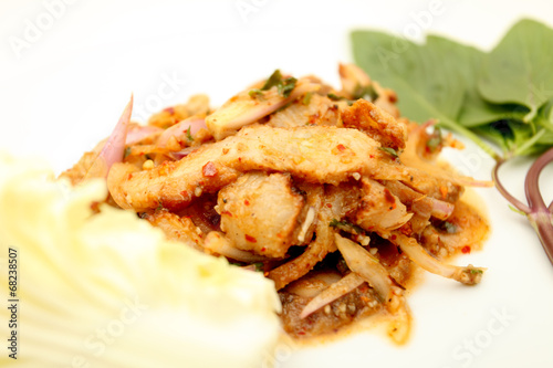 Thai cuisine spicy pork salad , Moo Nam Tok isolated white backg