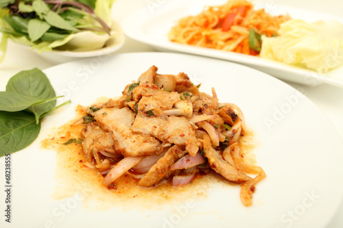 Thai cuisine spicy pork salad , Moo Nam Tok isolated white backg photo