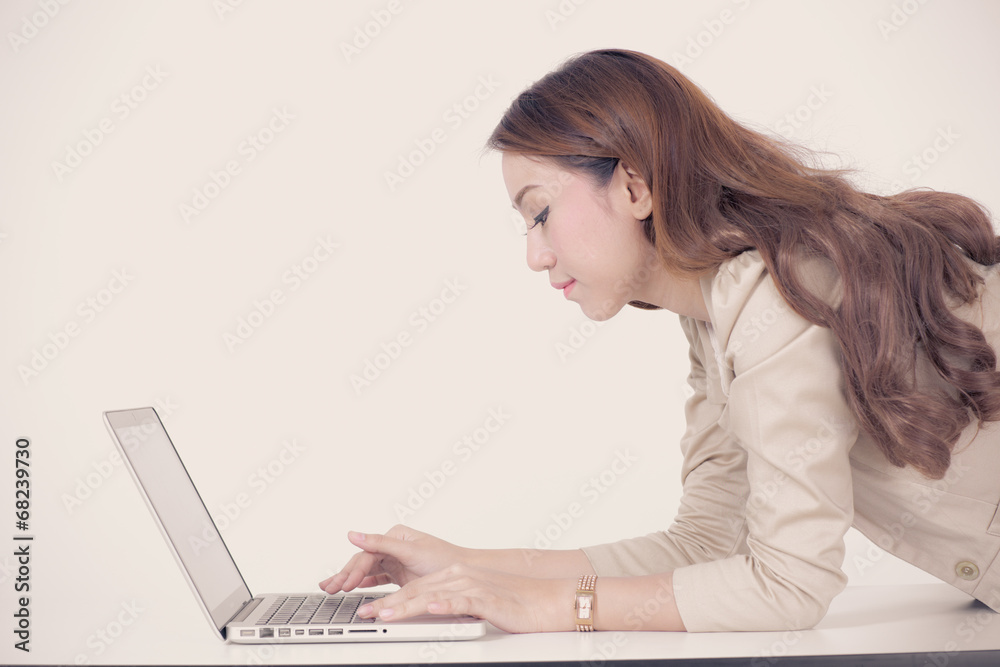 Portrait of a young business woman using laptop at office Portrait of a young business woman using laptop at office