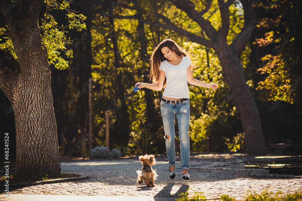 Fototapeta premium Woman beautiful young happy with long dark hair holding small do