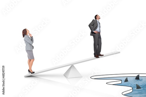 White scales measuring businessman and businesswoman