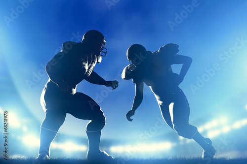 American football players in game, quarterback running. Game