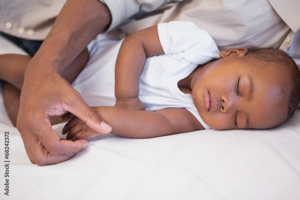 Happy father napping with baby son on couch Happy father napping with baby son on couch