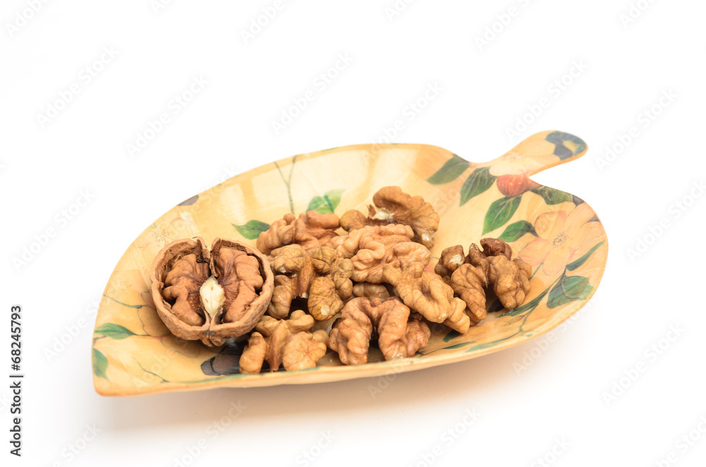 Cracked and purified walnuts in leaf shaped platter