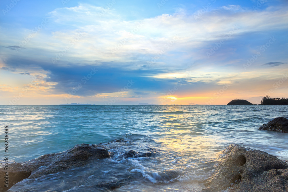 Panoramic dramatic tropical sunset sky and sea with rock surface