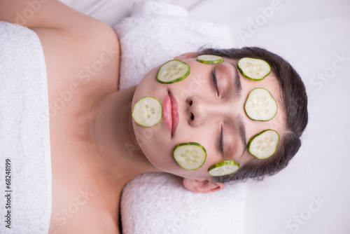 Beautiful woman with cucumber mask on her face