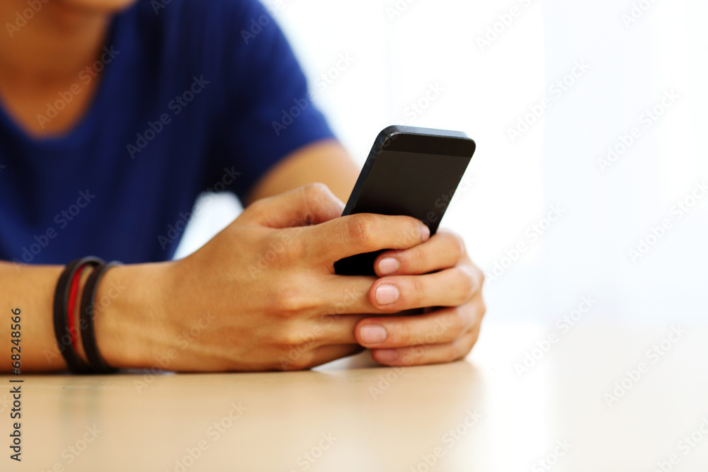 Closeup portrait of a male hands holding smartphone Closeup portrait of a male hands holding smartphone