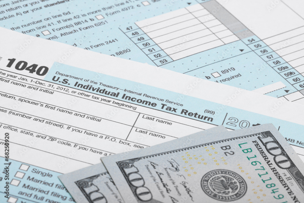 USA 1040 Tax Form with two 100 US dollar bills USA 1040 Tax Form with two 100 US dollar bills