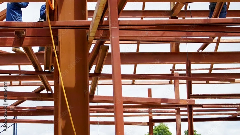 metal structure workers on the beam
