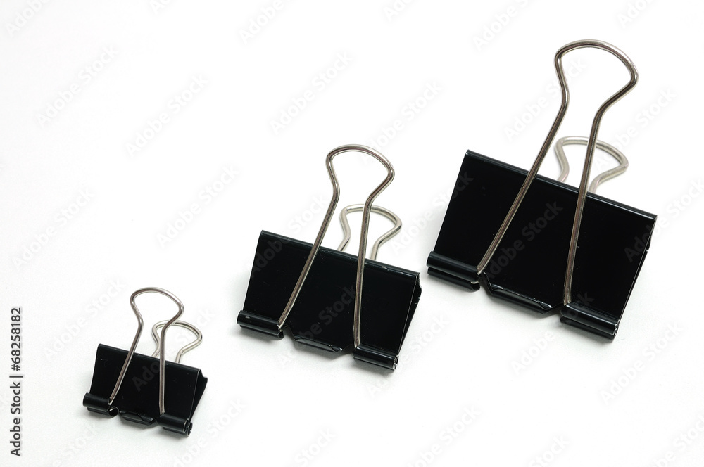 Three office paper clips of different sizes Three office paper clips of different sizes