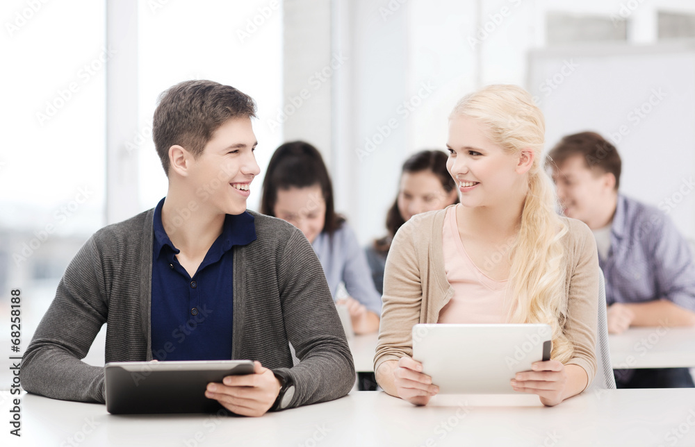 students looking at tablet pc in lecture at school students looking at tablet pc in lecture at school