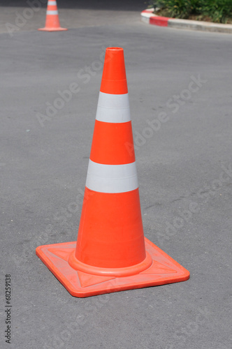 Orange traffic cone at park.