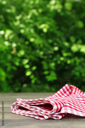 Wooden table with tablecloth, outdoors photo