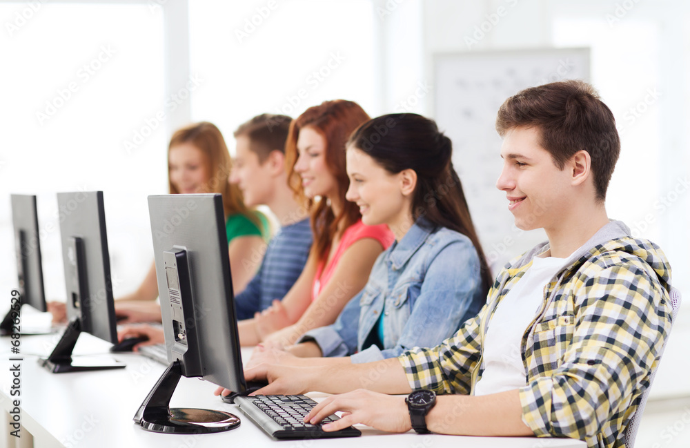 male student with classmates in computer class