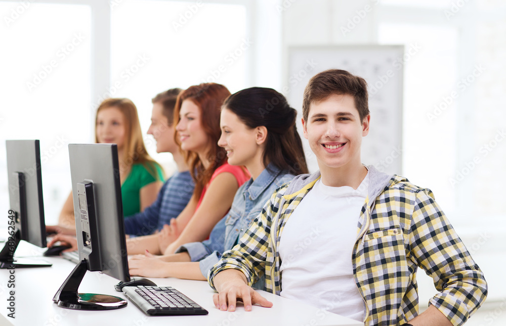 male student with classmates in computer class