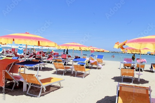 beach with umbrellas and sunbeds in Gatteo in Italy photo