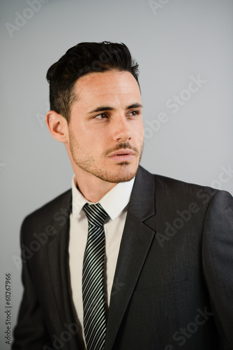 isolated portrait of handsome young businessman on trendy suit