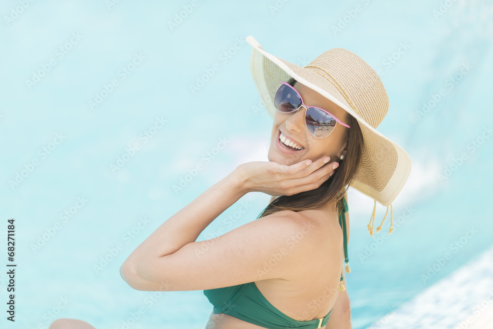 Pretty young woman by the pool