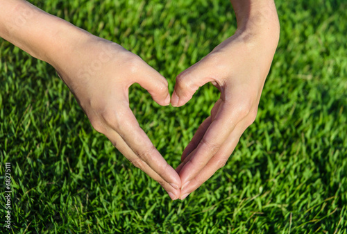 young girl hand make heart