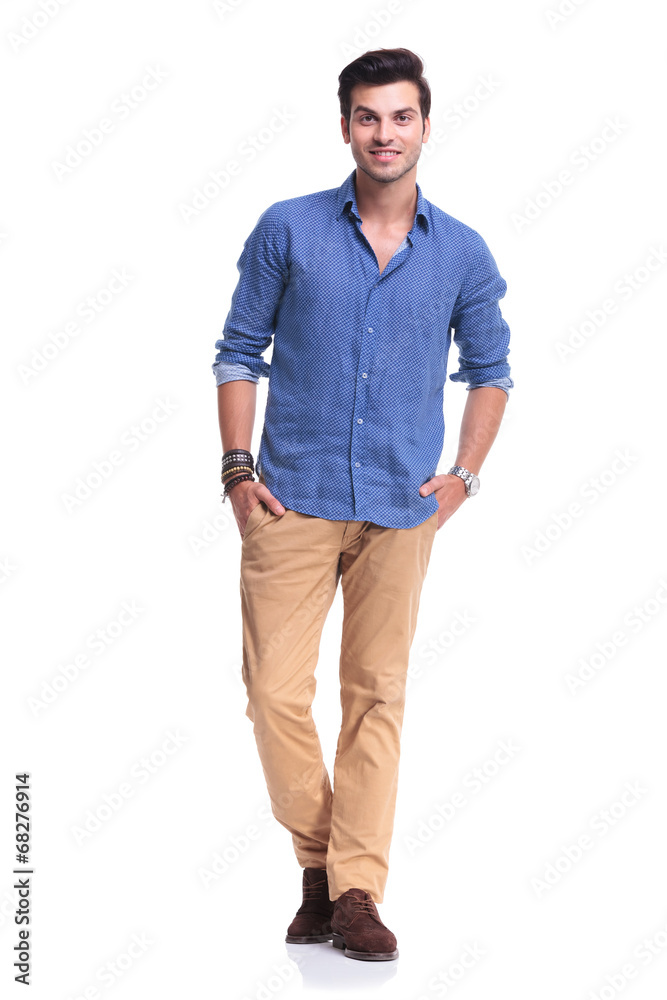 smiling casual man standing with hands in pockets smiling casual man standing with hands in pockets