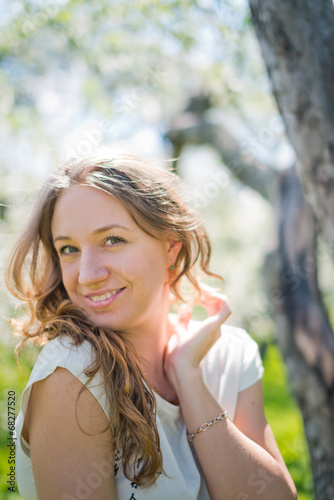 Young woman outdoors portrait. Soft sunny colors.