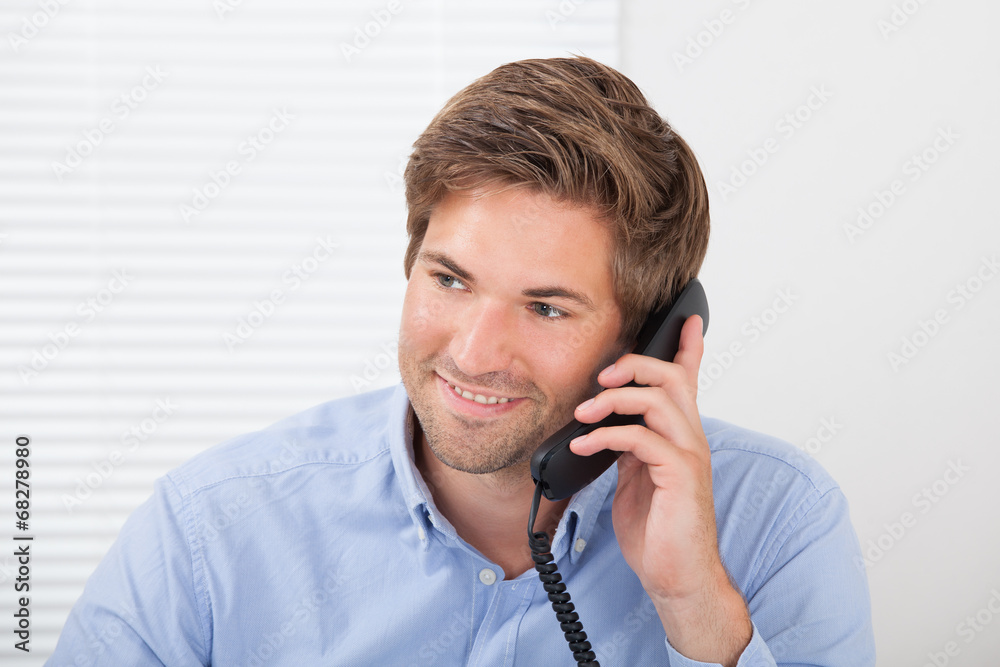 Businessman Communicating On Landline Phone Businessman Communicating On Landline Phone